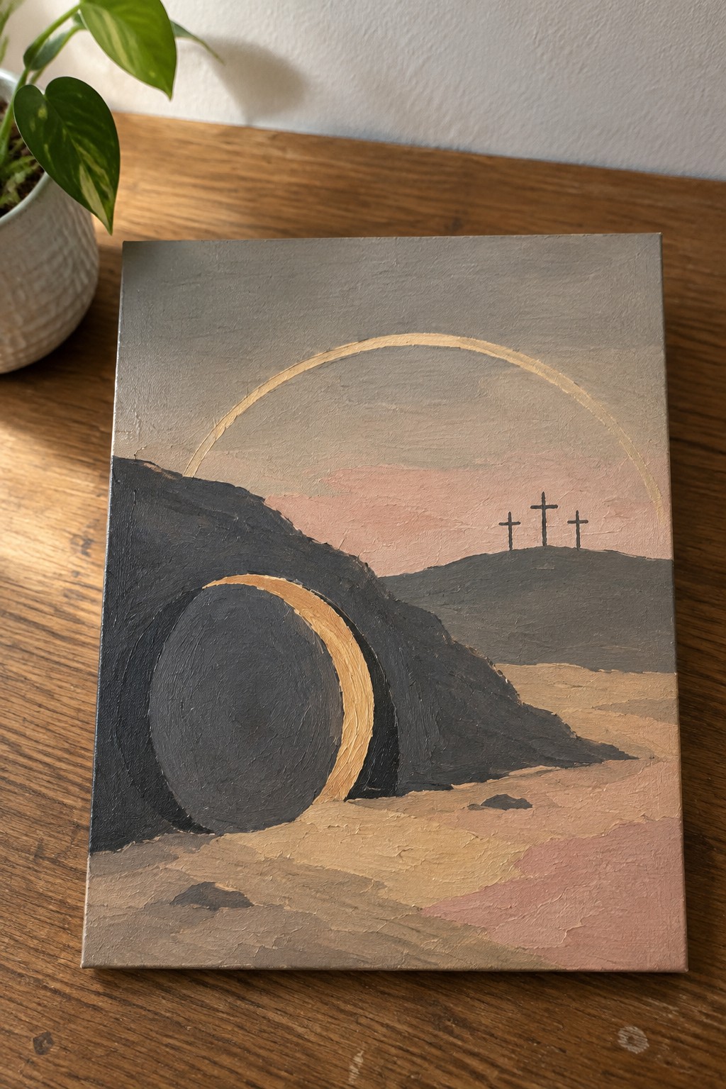 Canvas painting of three crosses on a hill with golden arc and dark circle.