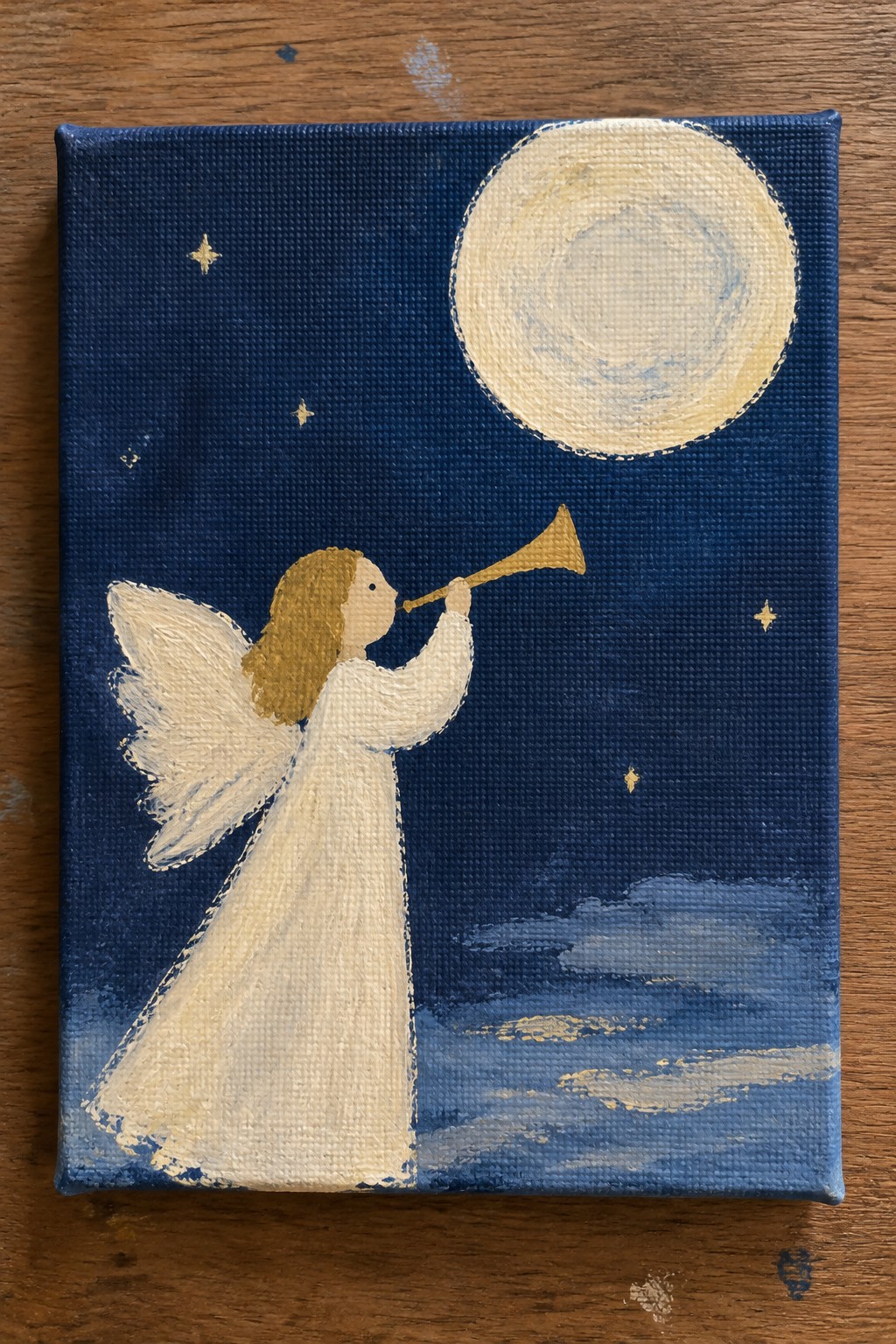 Angel in white gown blows golden trumpet under moon in starry night sky.