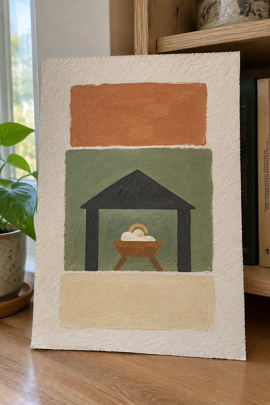 Abstract nativity painting with black stable, manger and halo on green, orange and beige panels