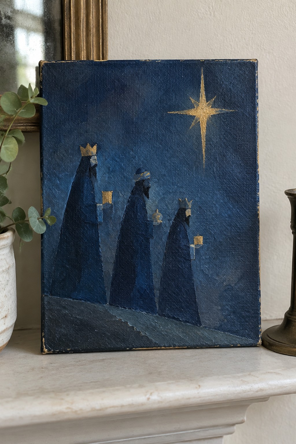 Three blue-robed kings with gold crowns and gifts walk toward a shining star.