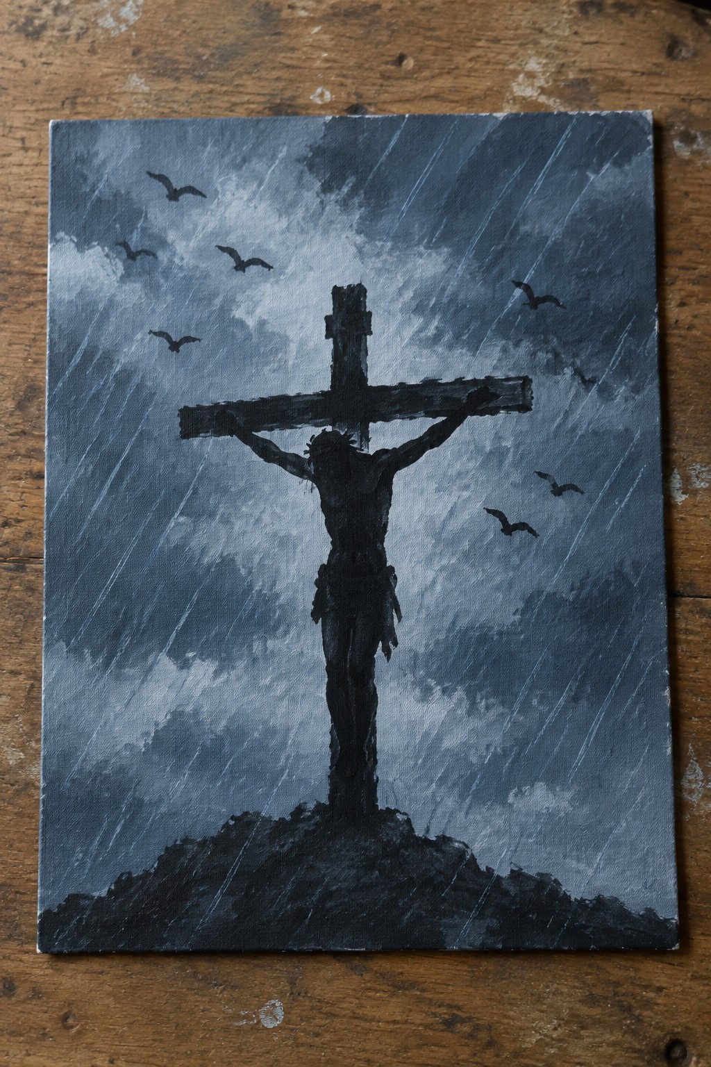 Crucified Jesus silhouette on cross against dark stormy sky with rain and flying birds