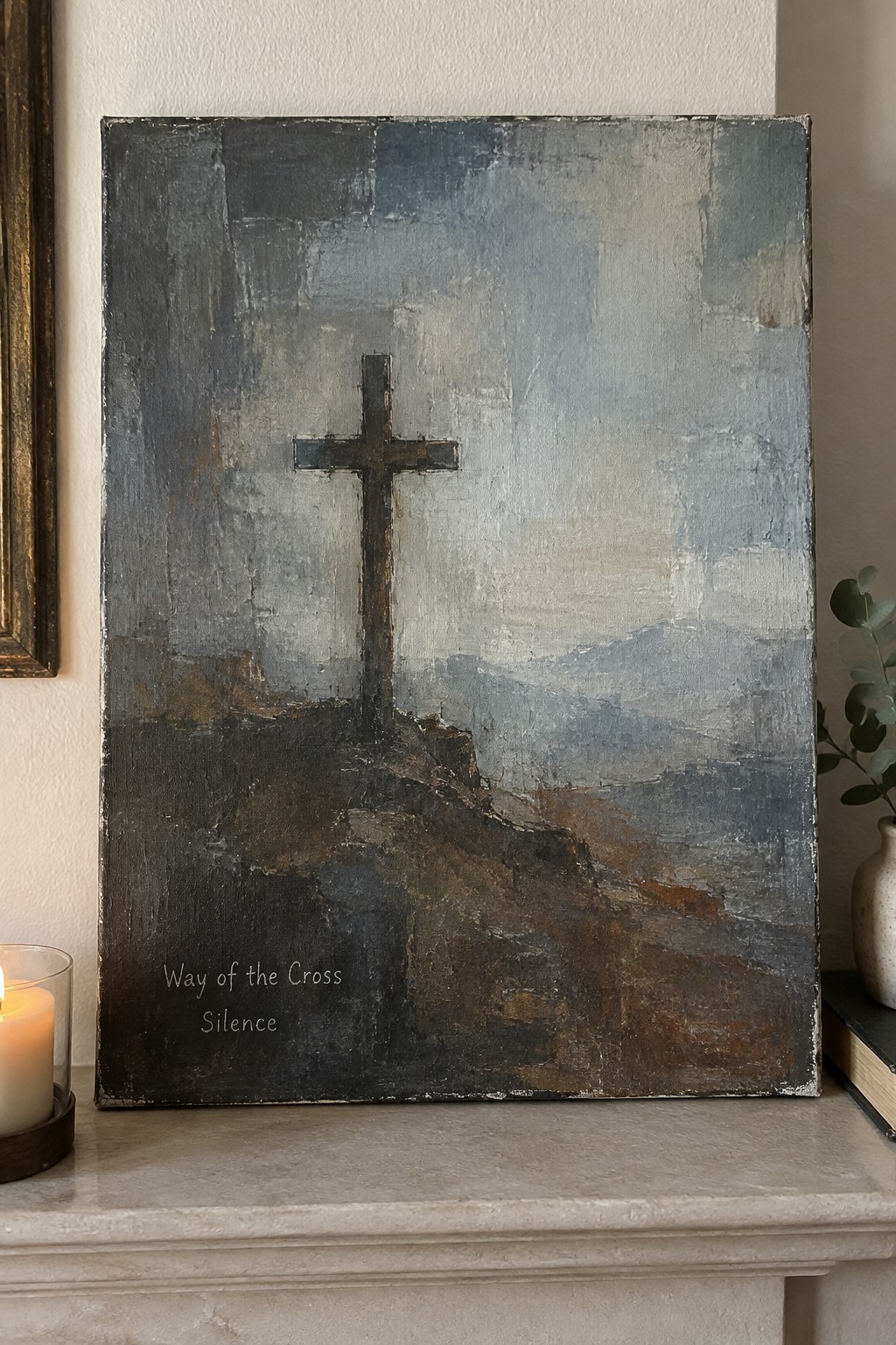Abstract painting of cross on rocky hill with text beside lit candle on mantel.