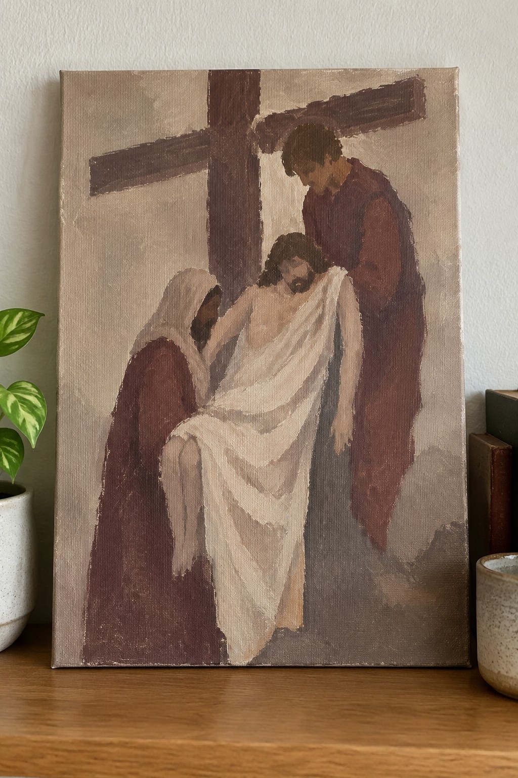 Oil painting of two robed figures supporting Jesus before a wooden cross.