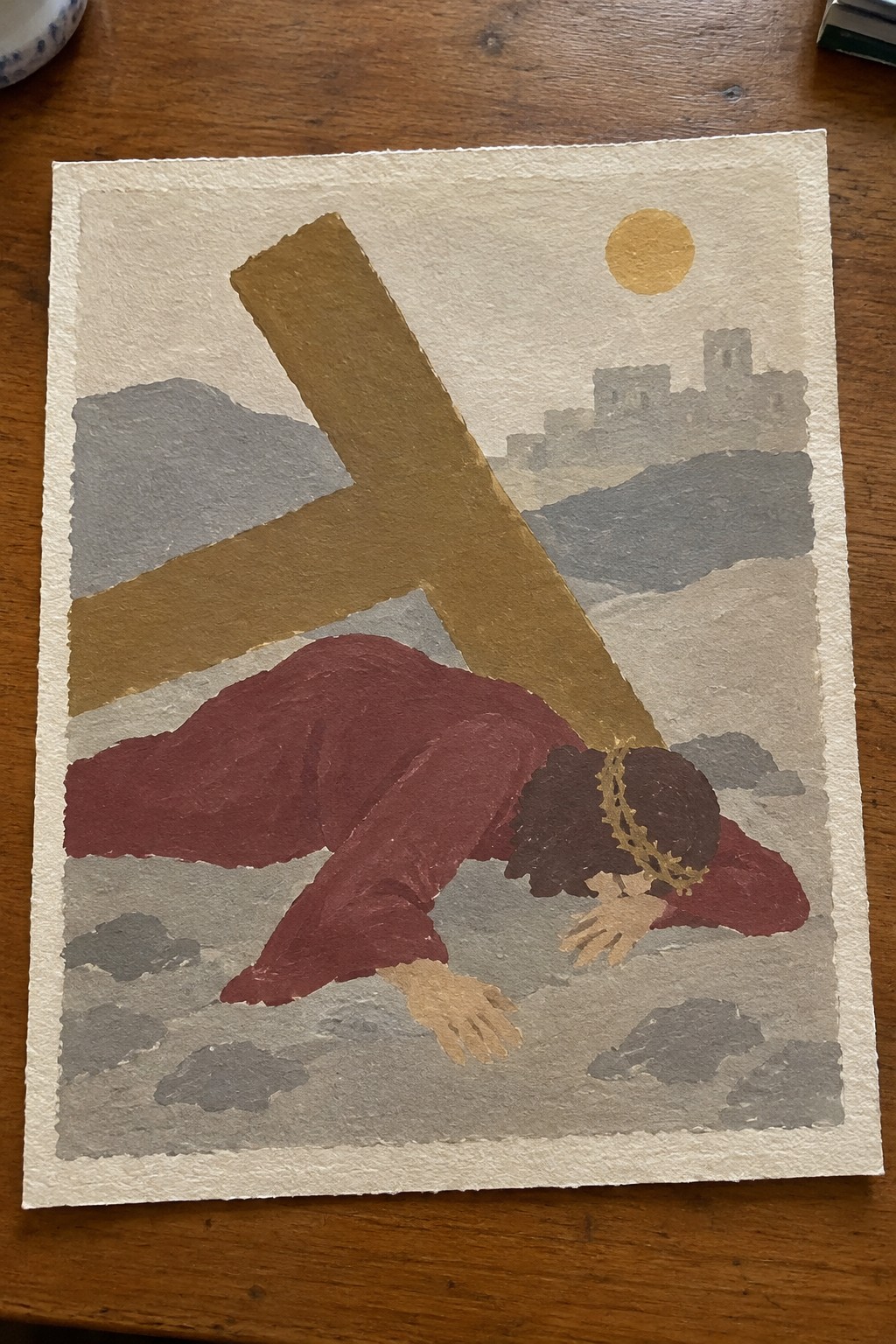Jesus in red robe fallen beneath large brown cross with golden crown and sun