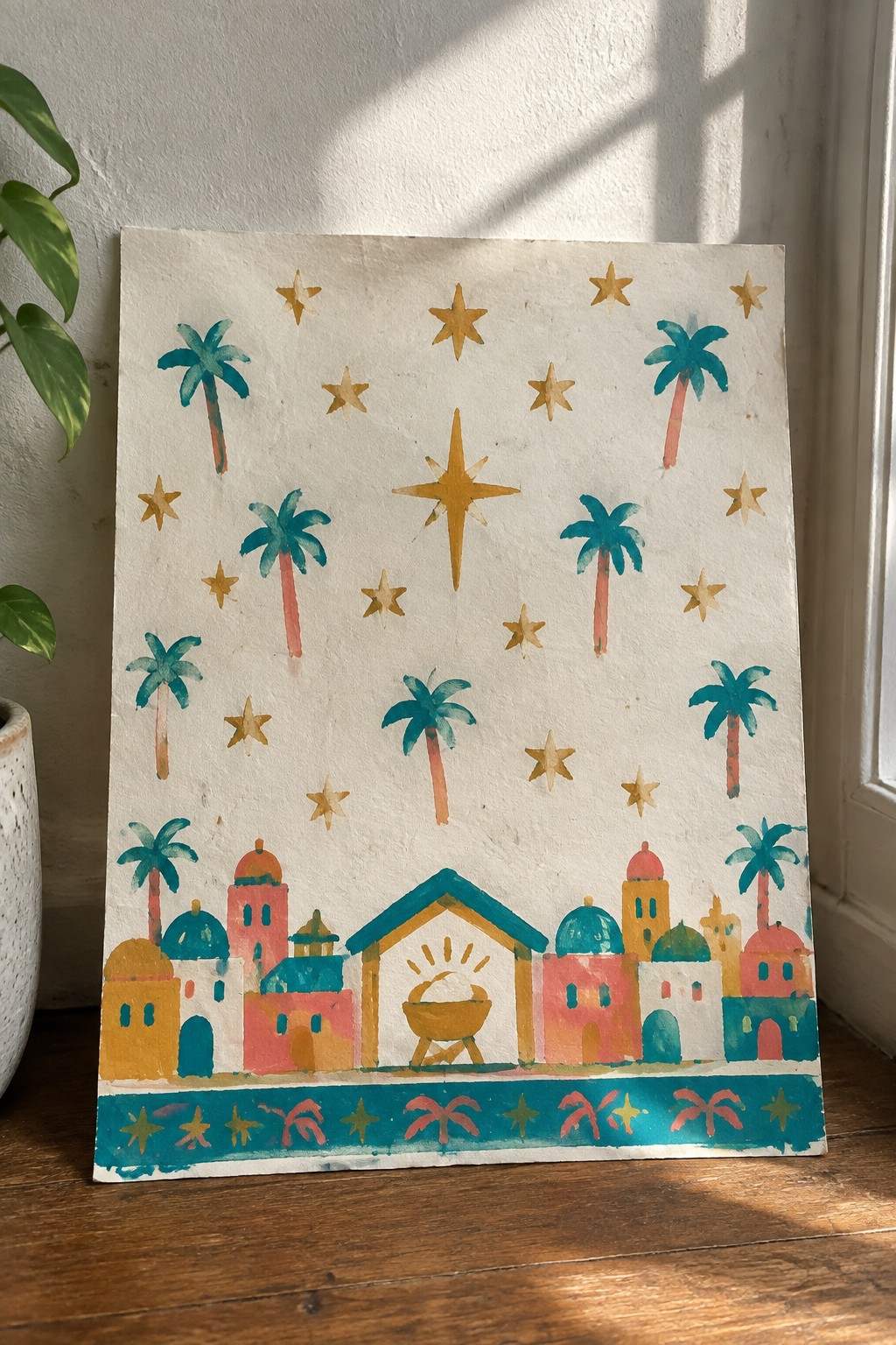 Colorful watercolor nativity scene with palm trees, golden stars, and domed buildings