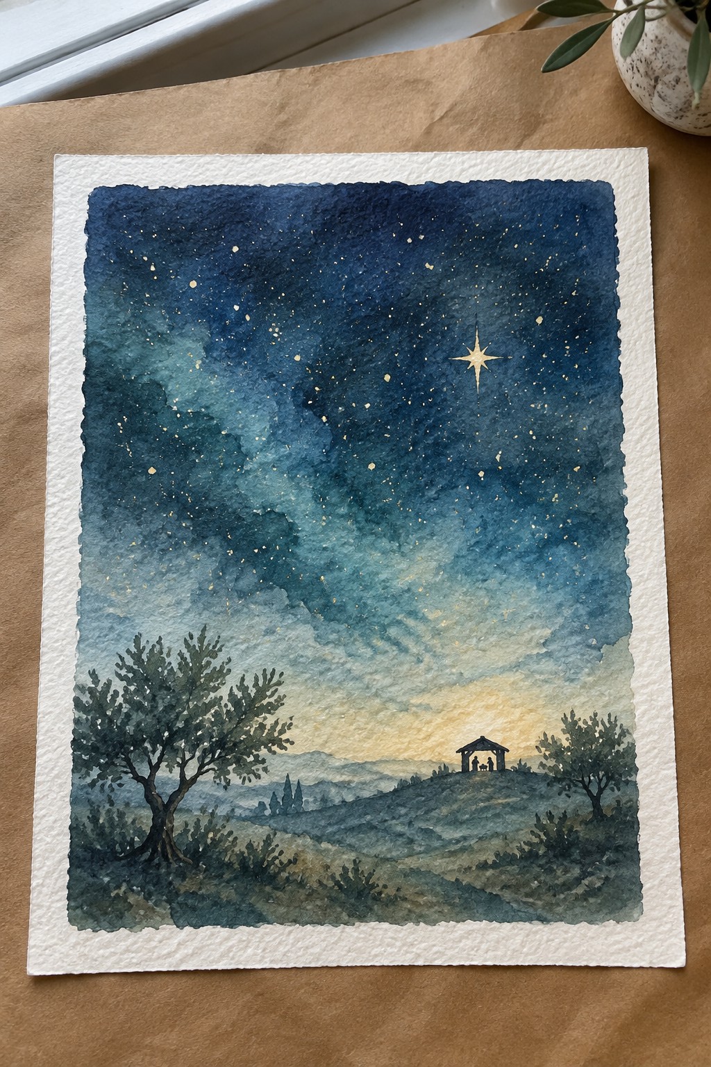 Watercolor of starry blue night sky with bright star above trees and hilly landscape