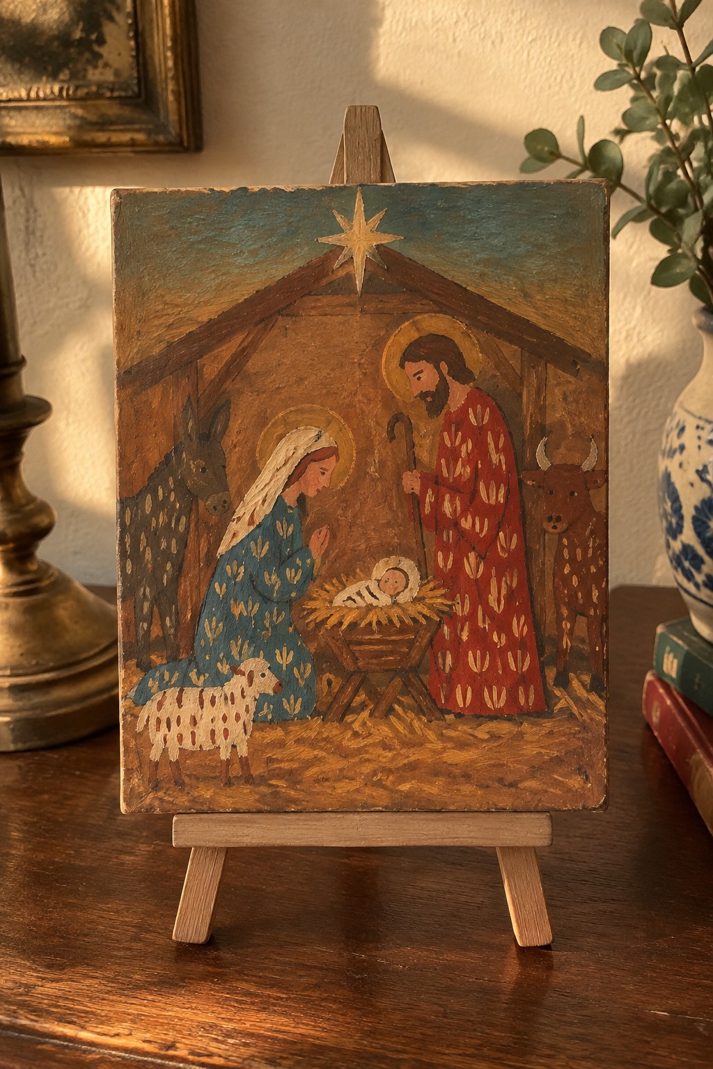Folk painting of Nativity with Mary in blue, Joseph in red, animals, and star.