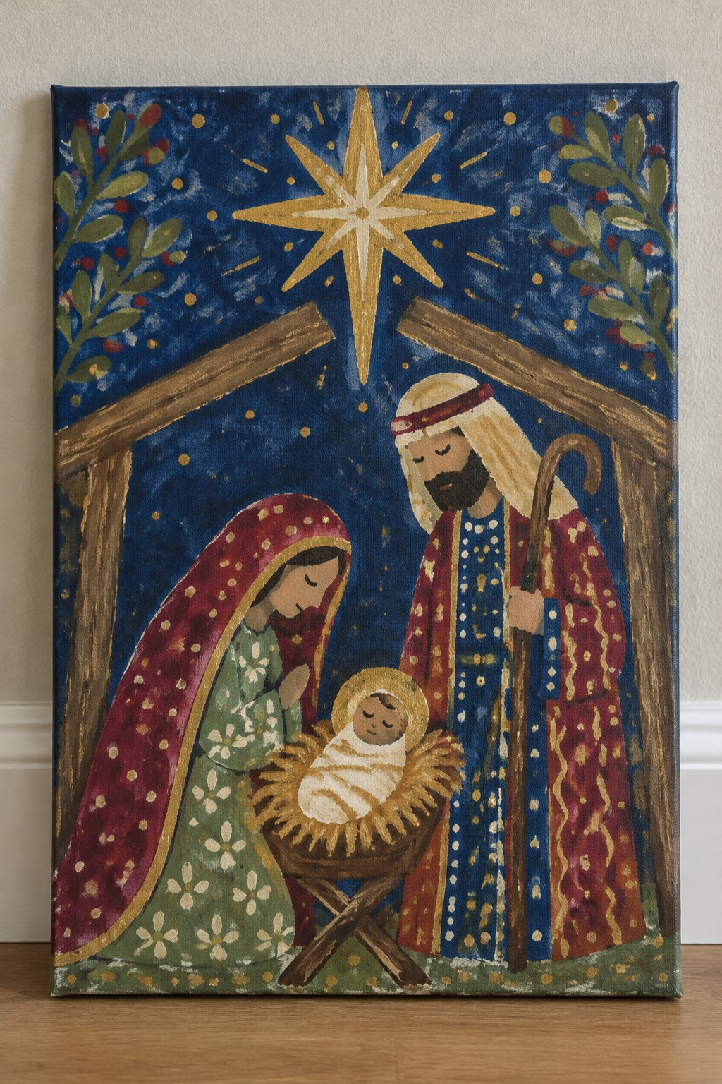 Colorful folk-art nativity painting with Mary, Joseph, manger, and large golden star at night.