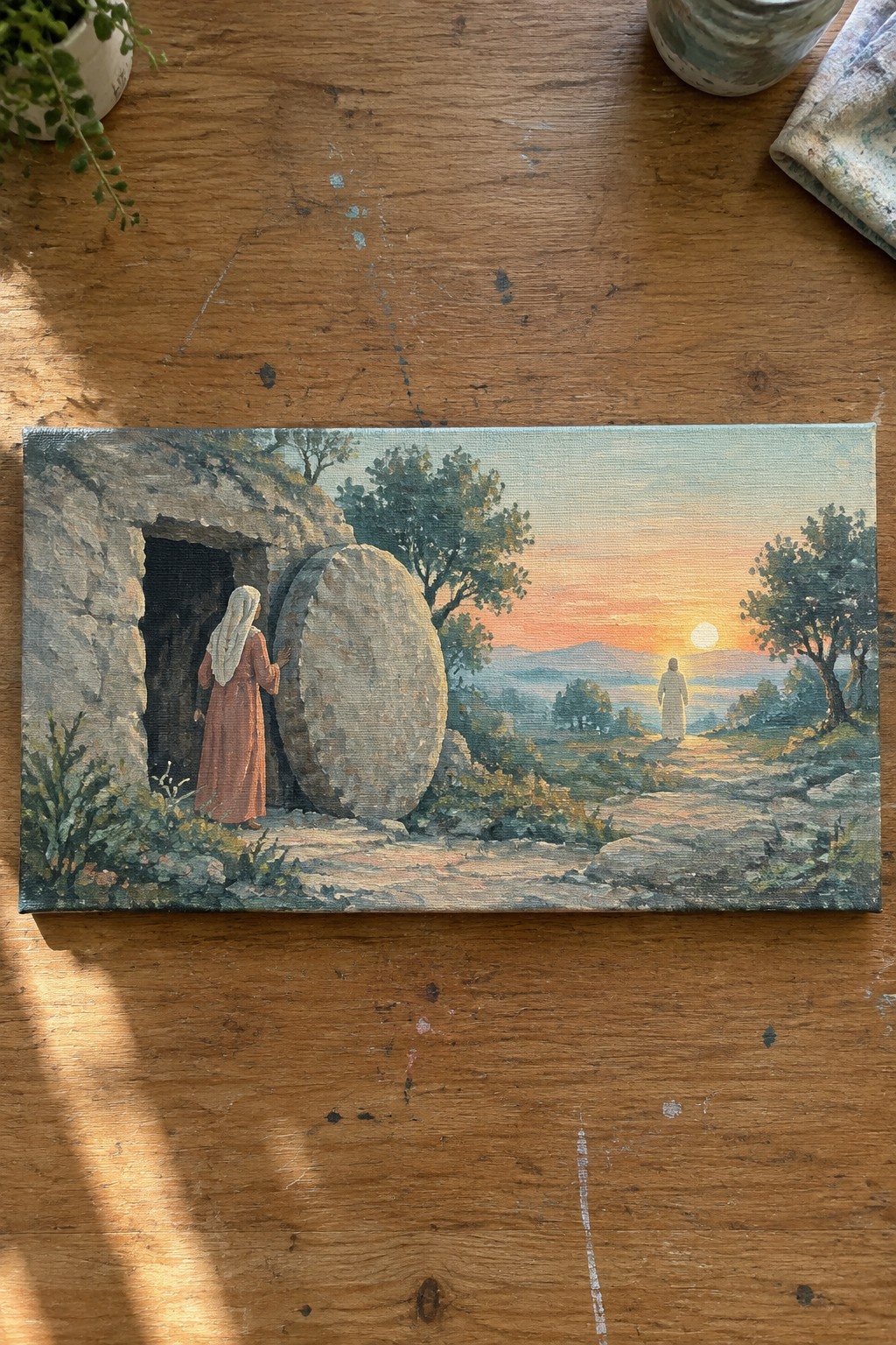 Woman in reddish robe at empty stone tomb with large round boulder, distant figure at sunset