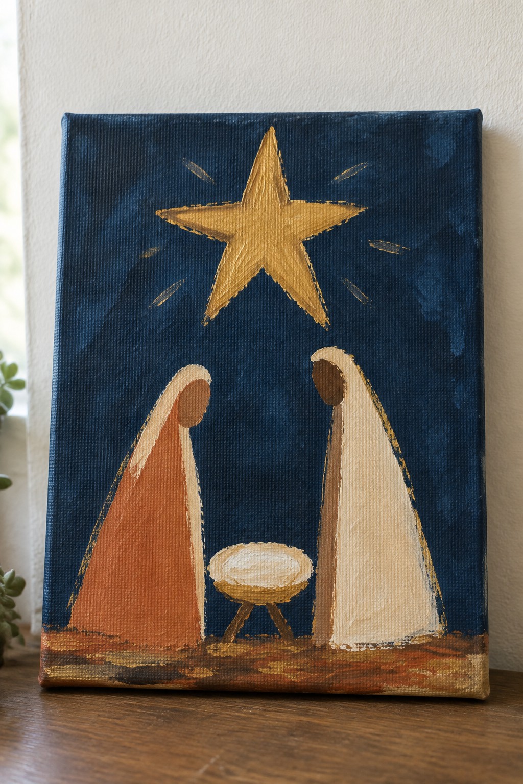 Two robed figures in orange and white stand by a manger under a golden star.
