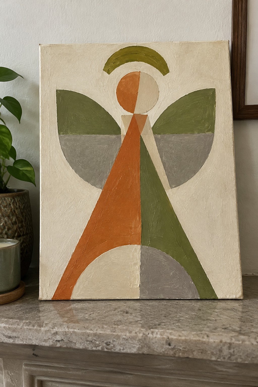 Abstract geometric painting of winged angel figure in orange, green, and gray shapes.
