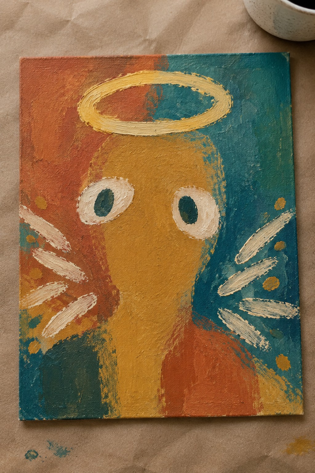Abstract painting of haloed yellow face with large eyes on orange-teal background.
