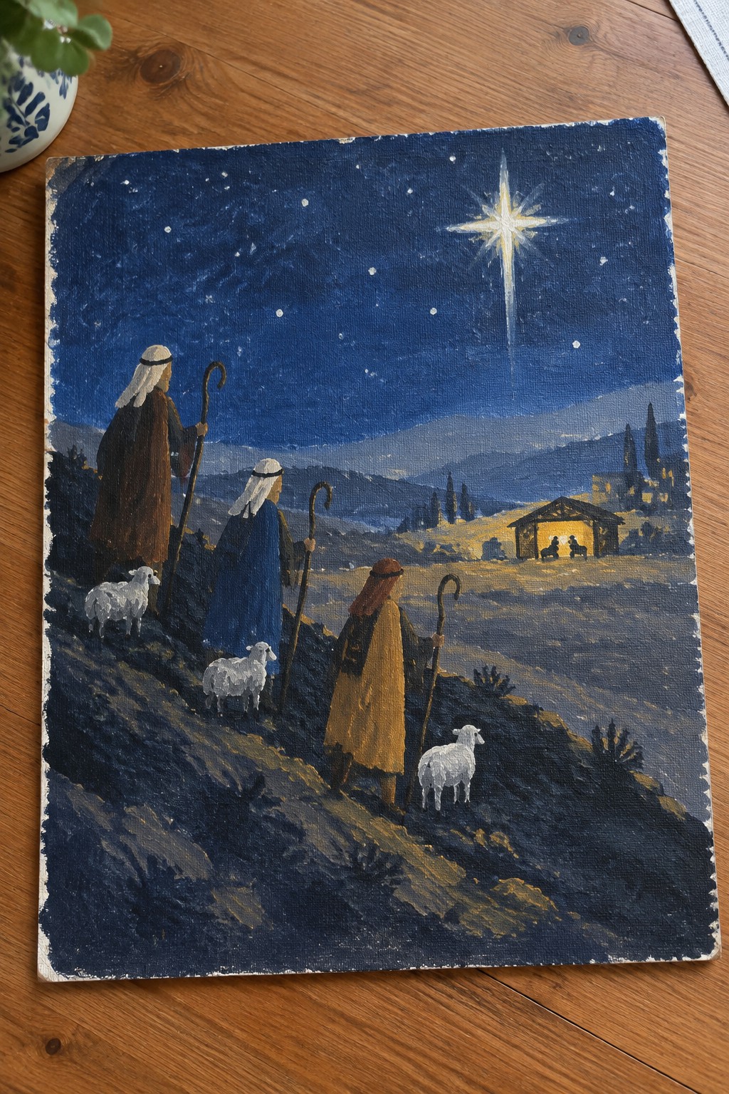 Three robed shepherds with staffs and sheep approach a lit stable under a bright star.